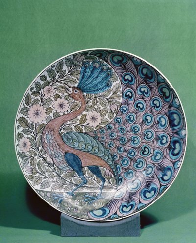 Earthenware dish with a peacock pattern by William de Morgan